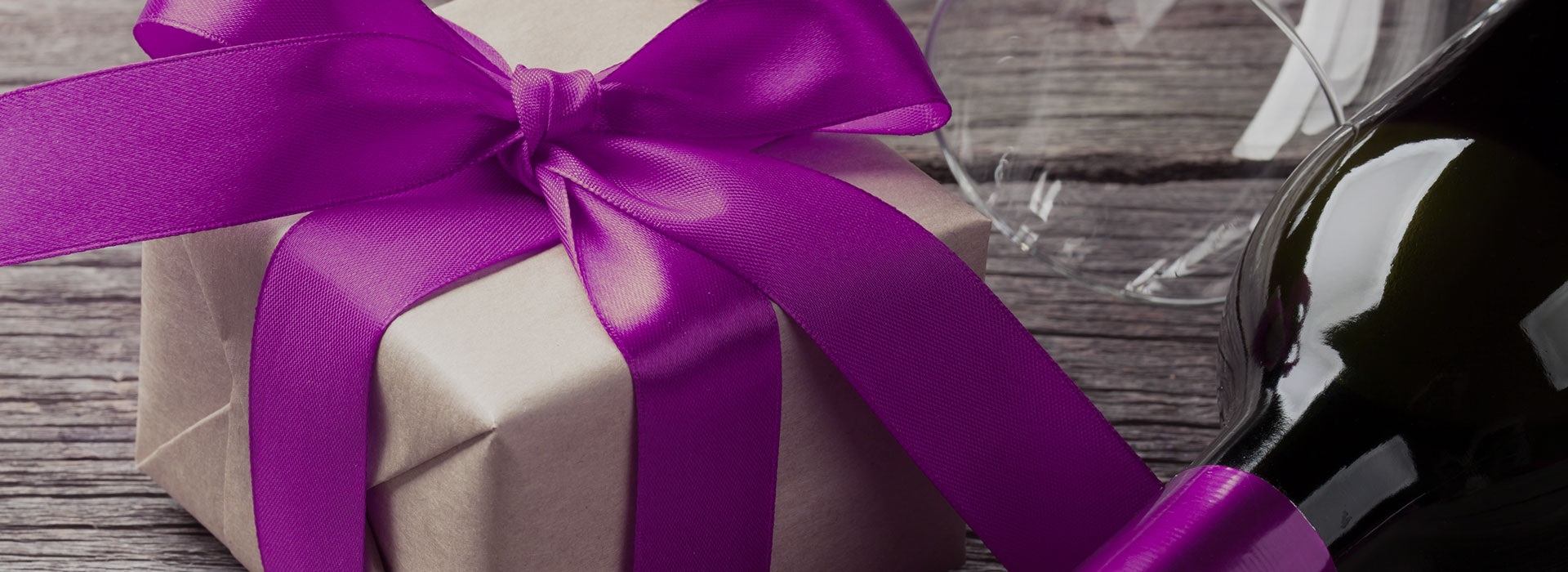 Box wrapped with giant purple ribbon